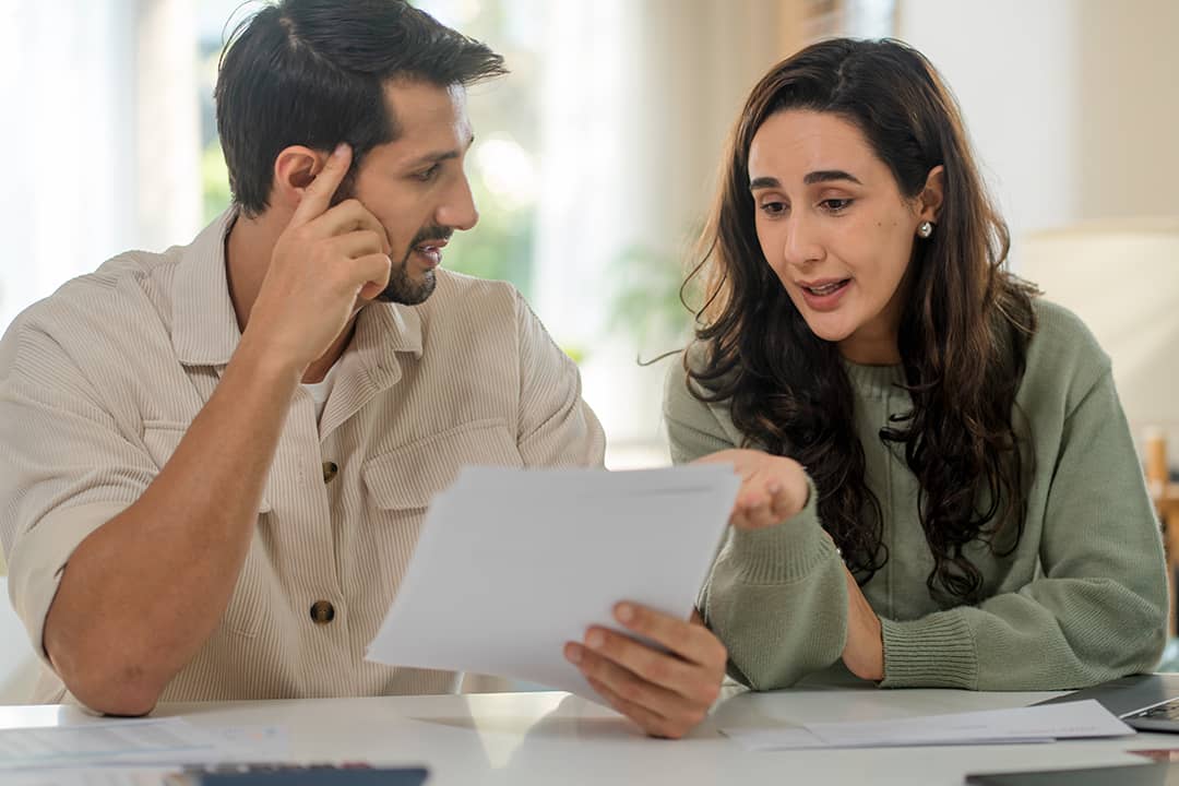 A couple discussing insurance paperwork